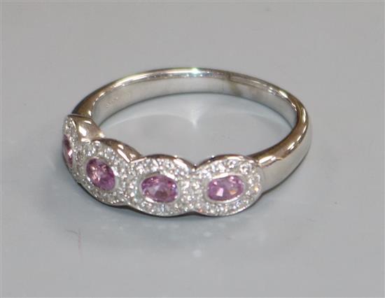 An 18ct white gold, pink sapphire and diamond quadruple cluster ring, size R.